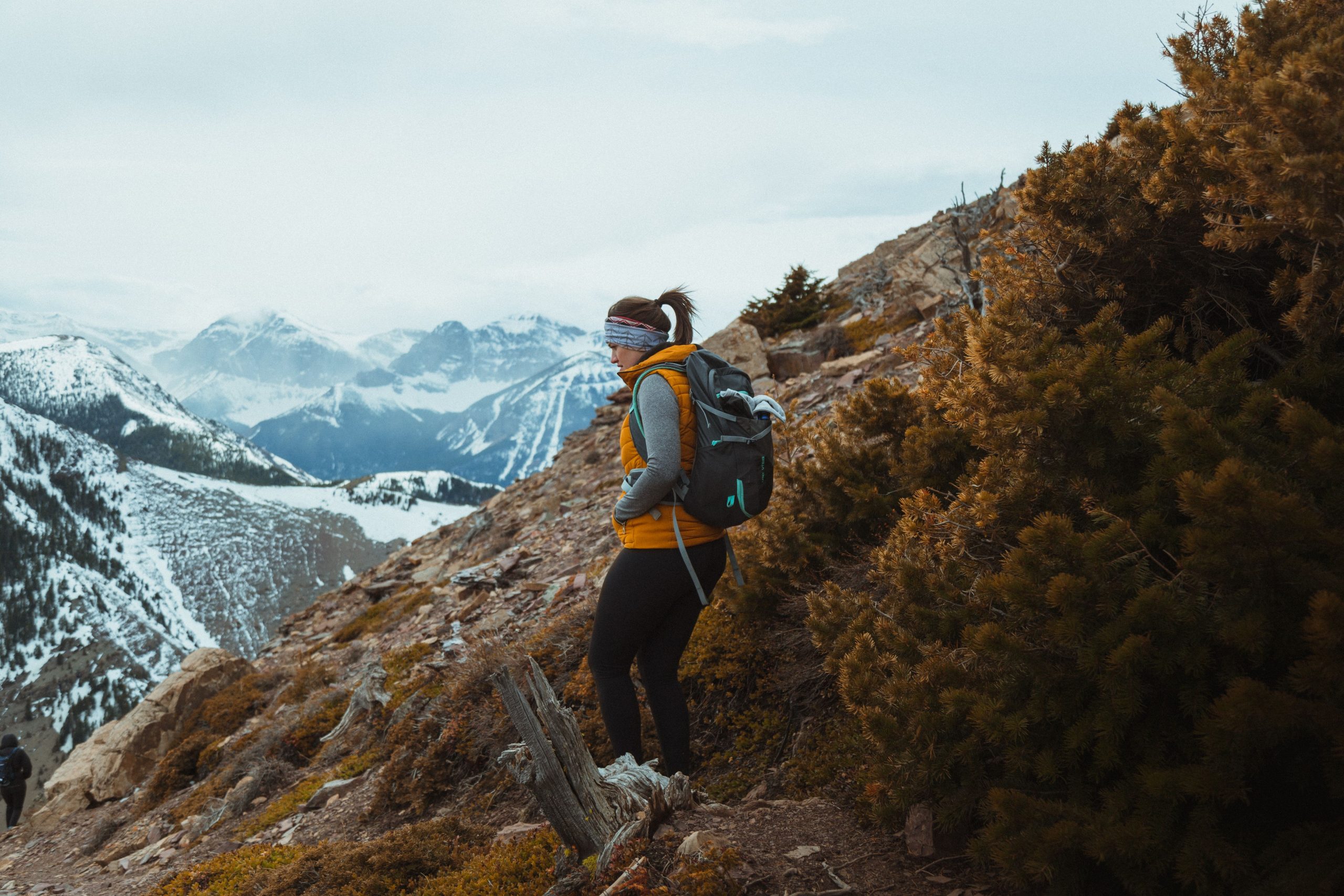 Woman trekking through a scenic mountain landscape, embracing an outdoor adventure at her own pace